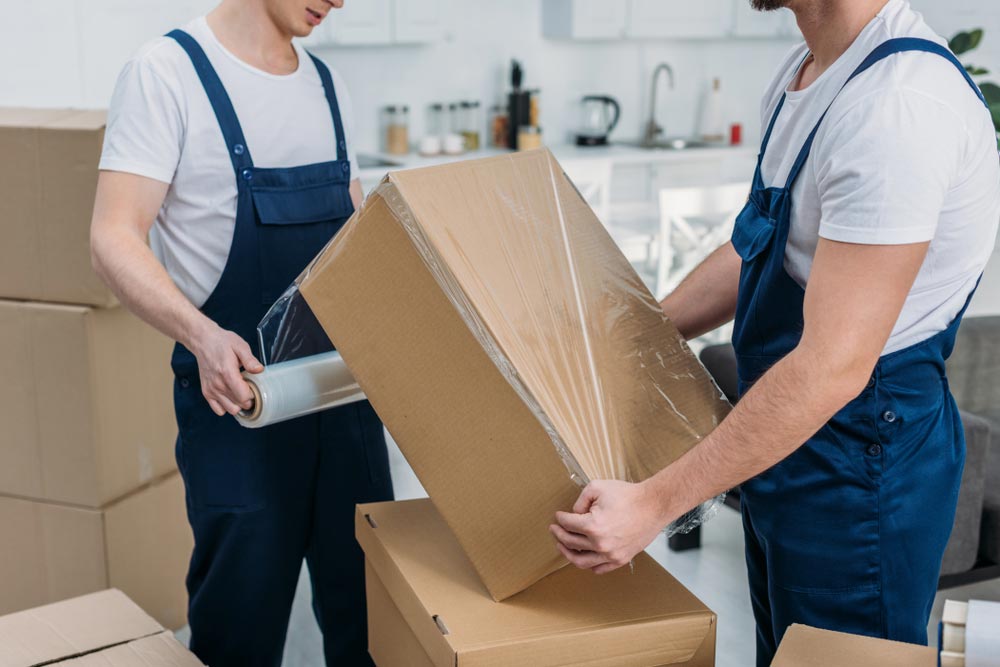 Removalist Carefully Covering A Moving Box In Illawarra, NSW